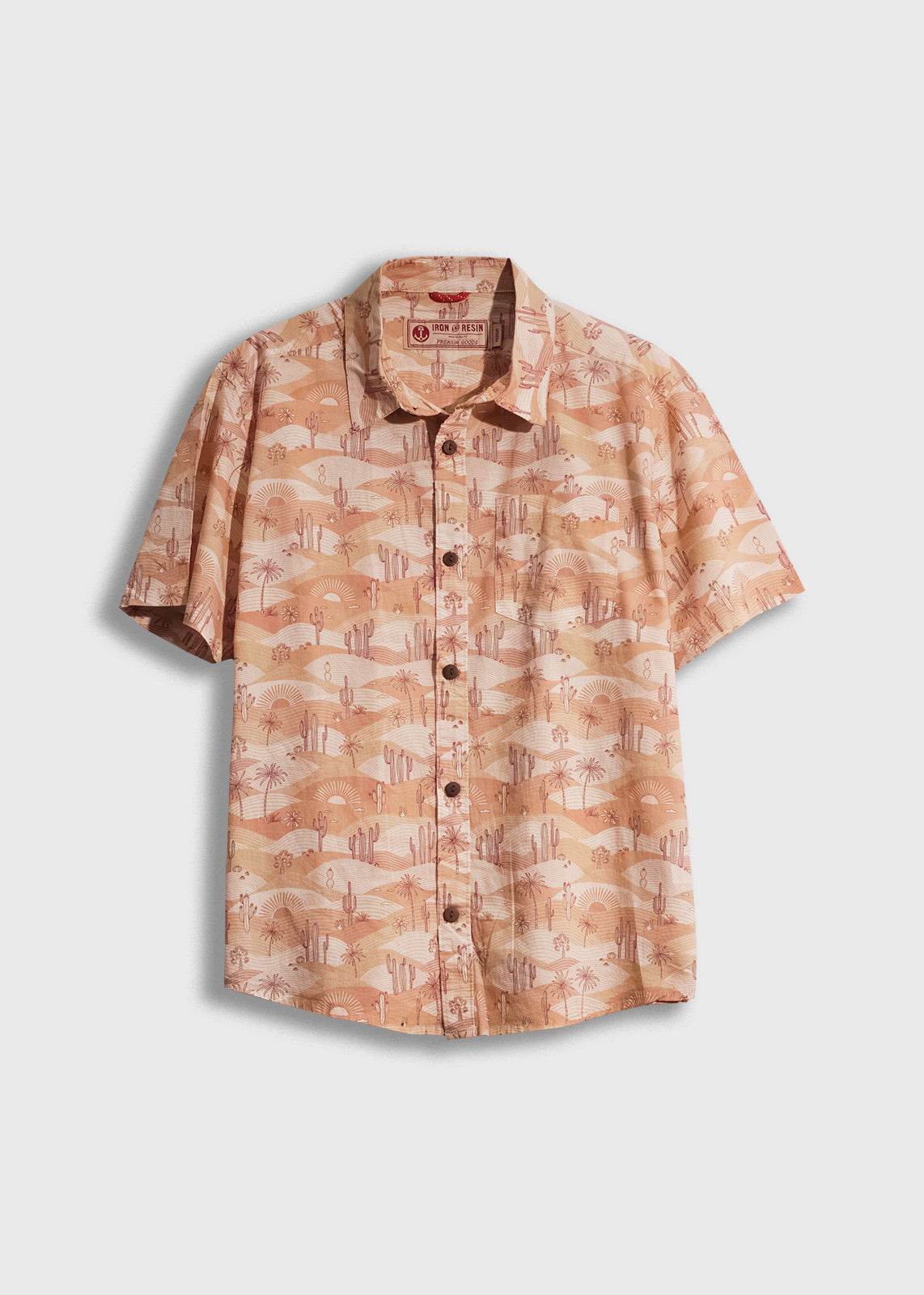 Short-sleeve shirt with desert landscape print, featuring cacti and sun motifs. Light brown tones, button-up front.