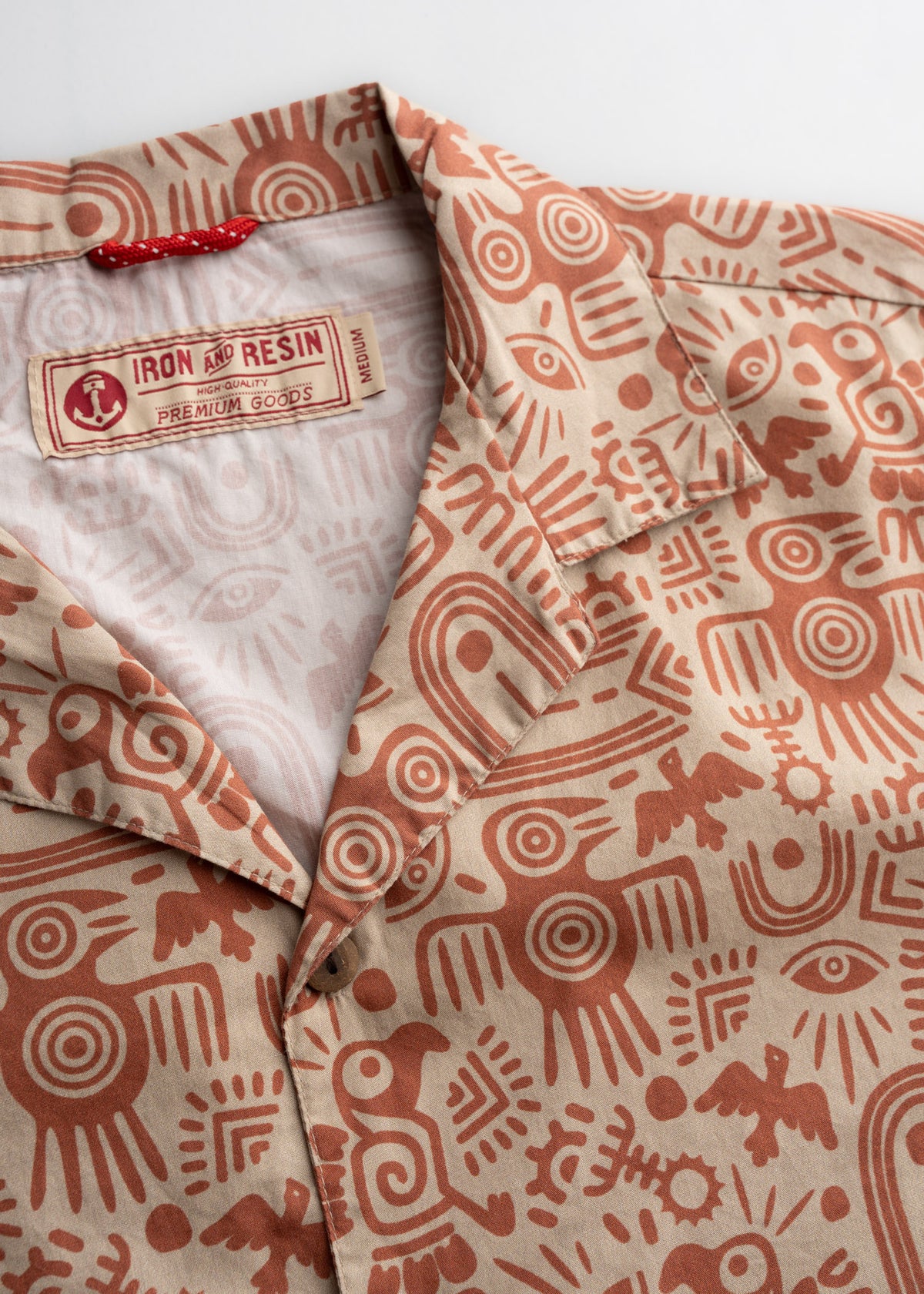 Men’s poplin cotton button up shirt, detailed close-up to showcase quality of fabric, graphic, buttons and custom woven tag