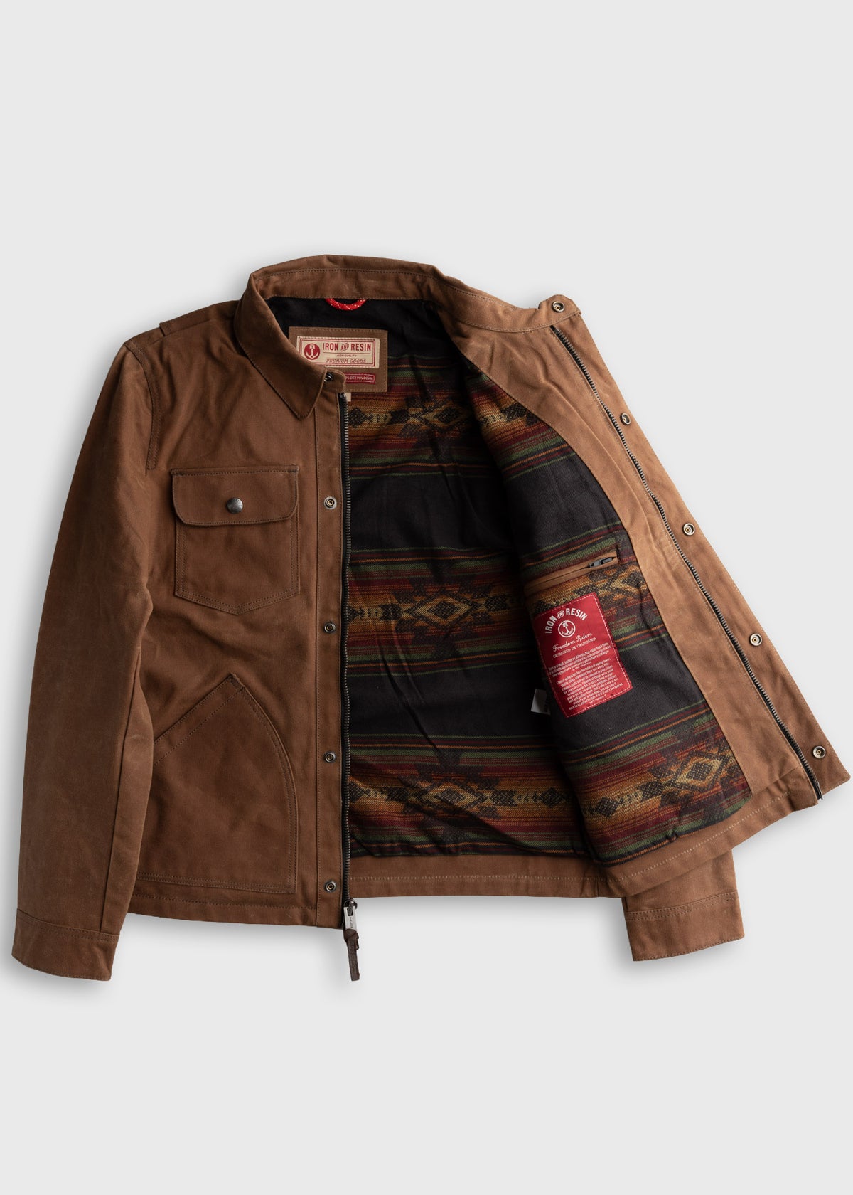Brown jacket with open front reveals a colorful patterned lining. Features buttoned chest pocket and zipper closure.