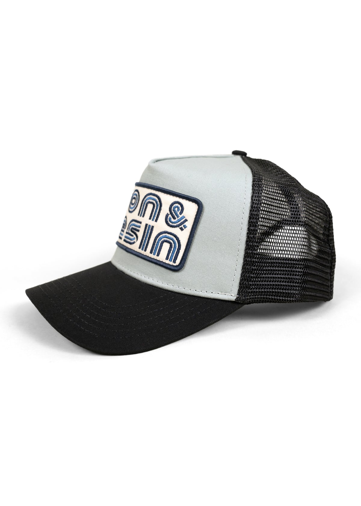 Black and gray trucker hat with mesh back and embroidered "Bons & Basin" logo on front, angled view on white background.