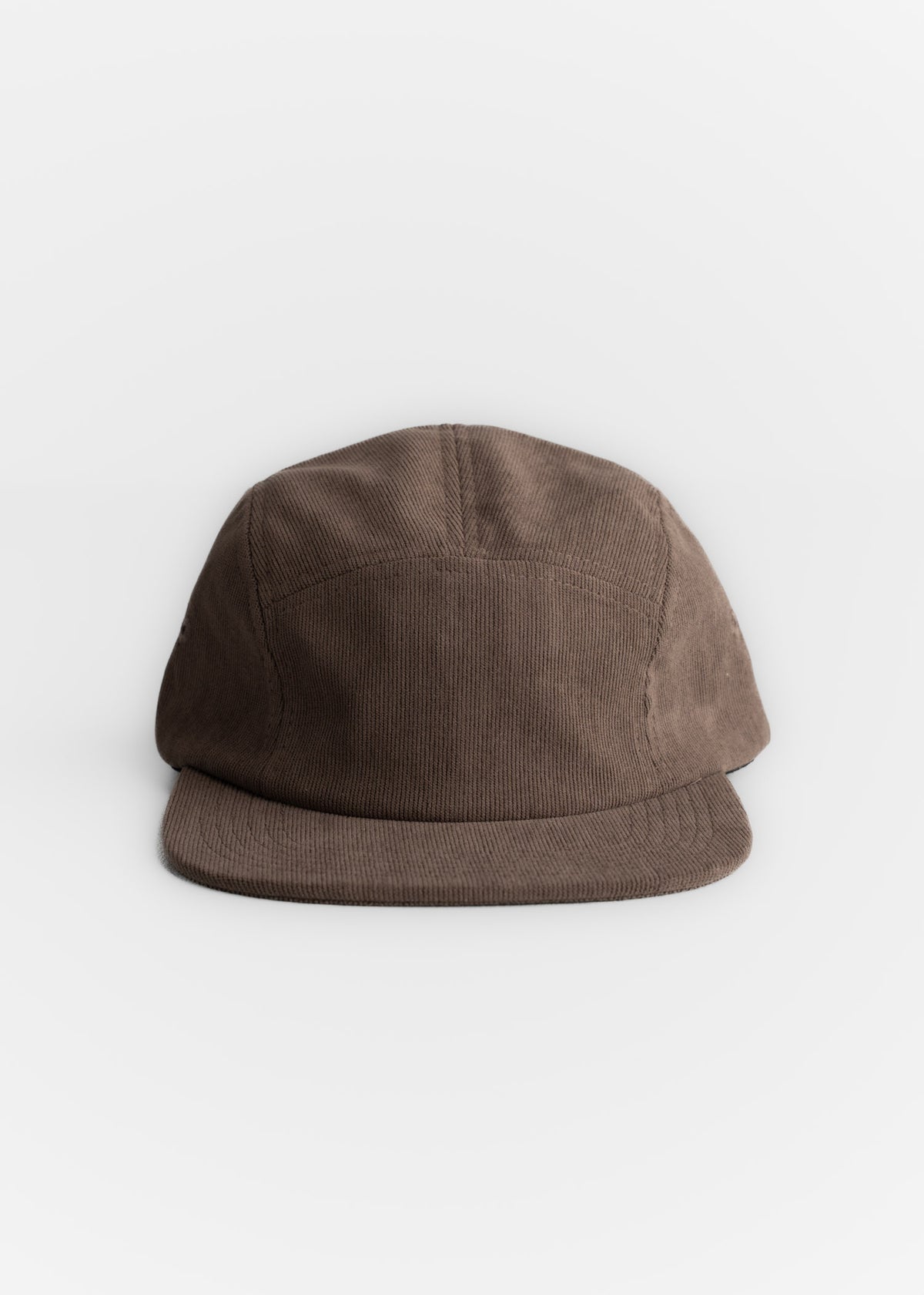 Brown corduroy cap with a flat brim, centered on a white background, showcasing its simple and classic design.