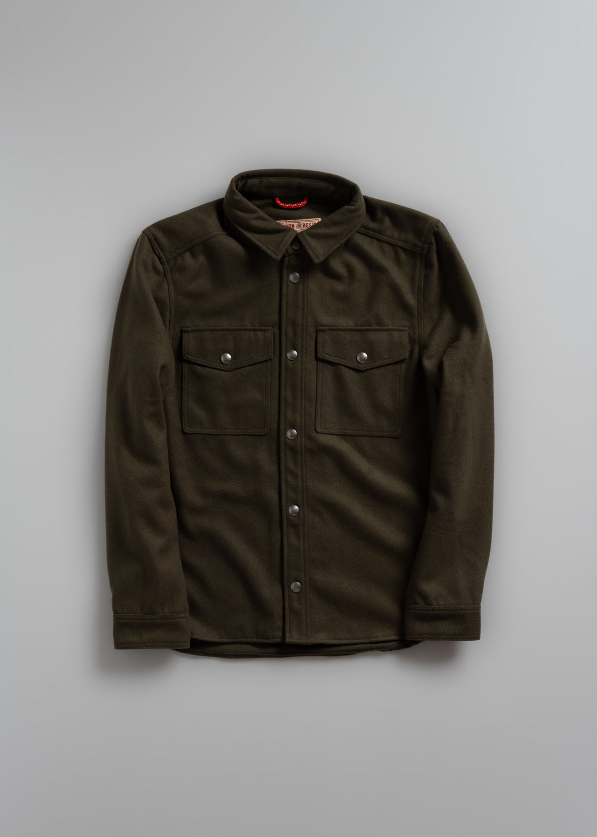 Olive green button-up shirt with two chest pockets and a collar, displayed on a plain gray background.