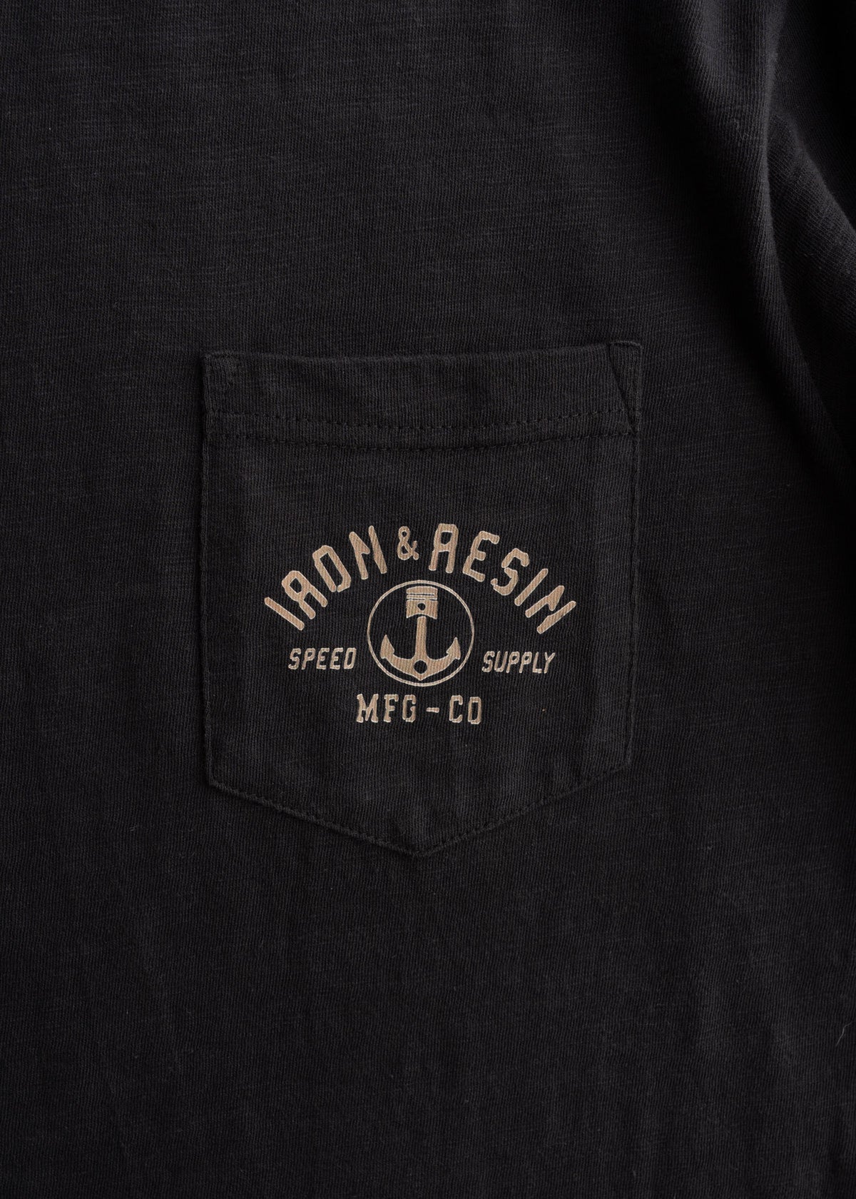 7.5 oz 100% Combed Cotton t-shirt in Black, close-up shot to showcase fabric detail, custom graphic and chest pocket