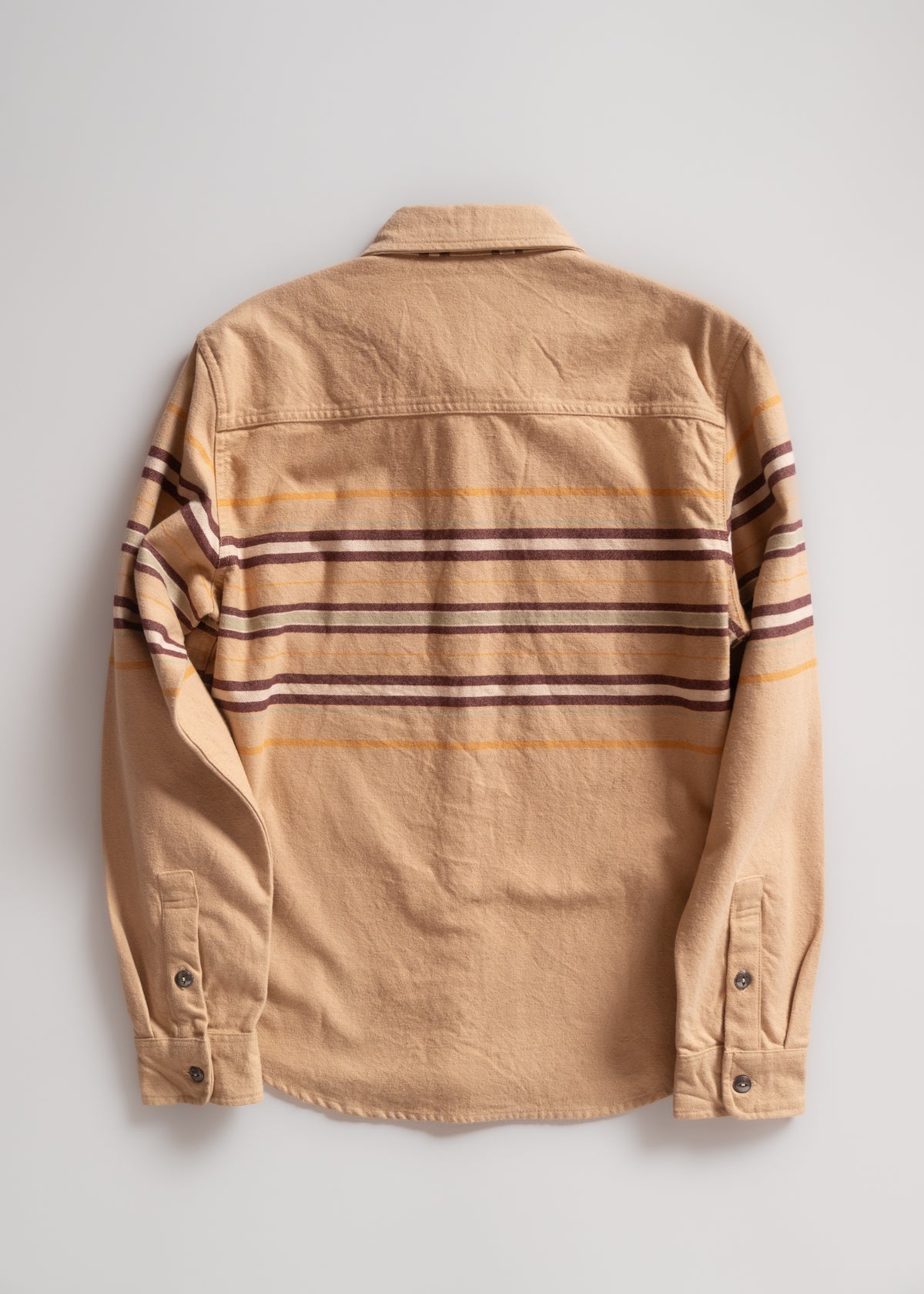 Tan flannel shirt with brown and yellow horizontal stripes, buttoned cuffs, and a collar, displayed on a plain background.