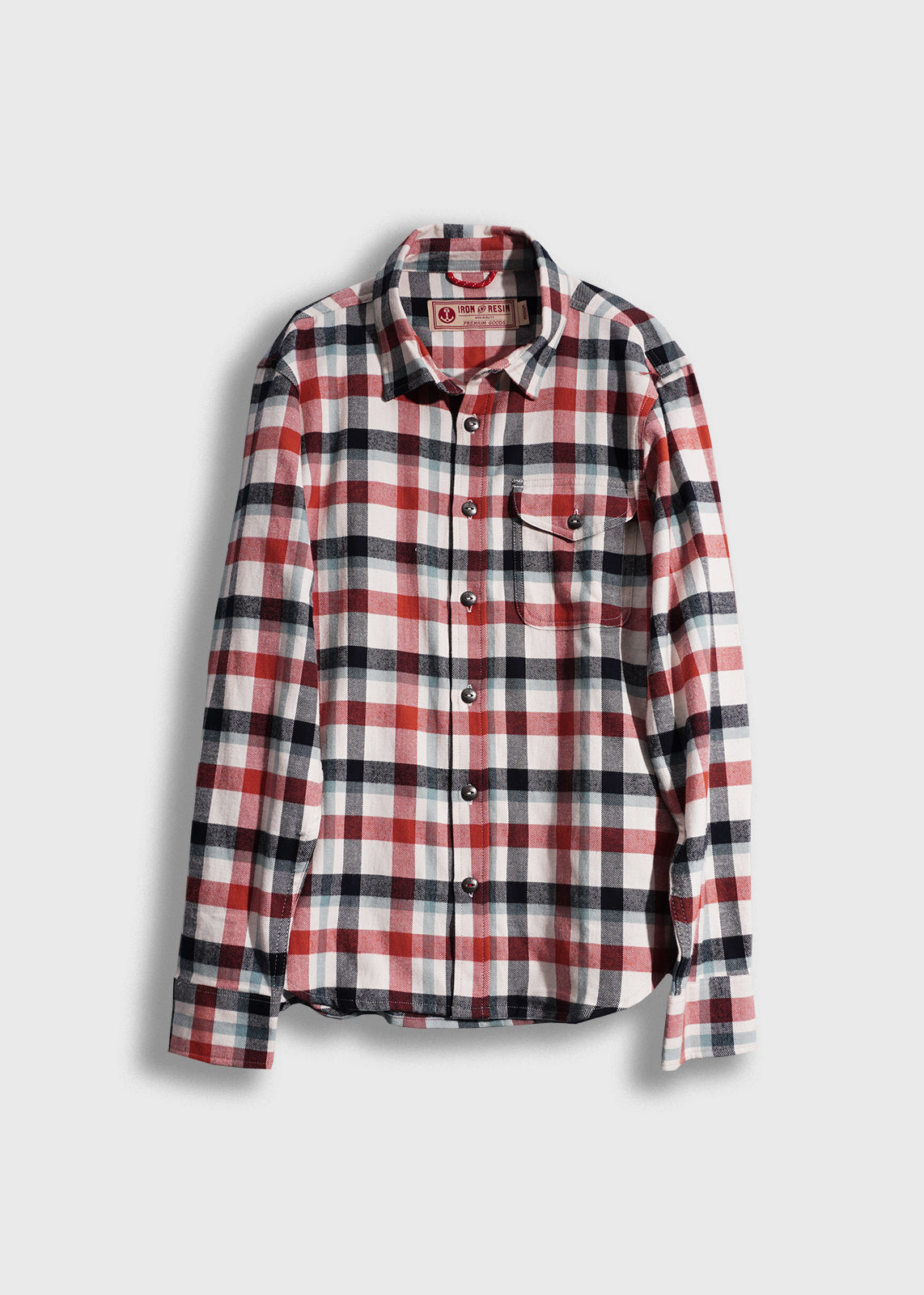 Red, black, and white plaid flannel shirt with buttons and a single chest pocket, displayed on a plain white background.