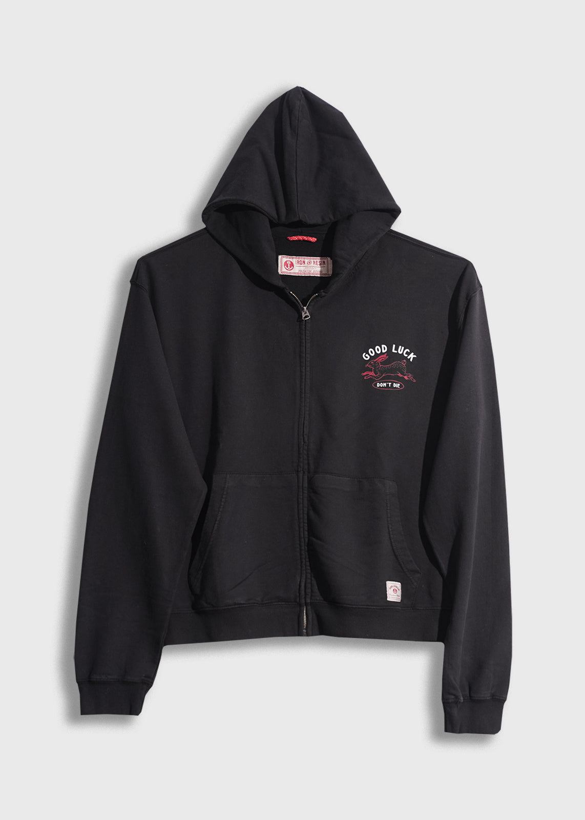 Black zip-up hoodie with "Good Luck" text and graphic on chest, featuring front pockets and a hood, displayed on a plain background.