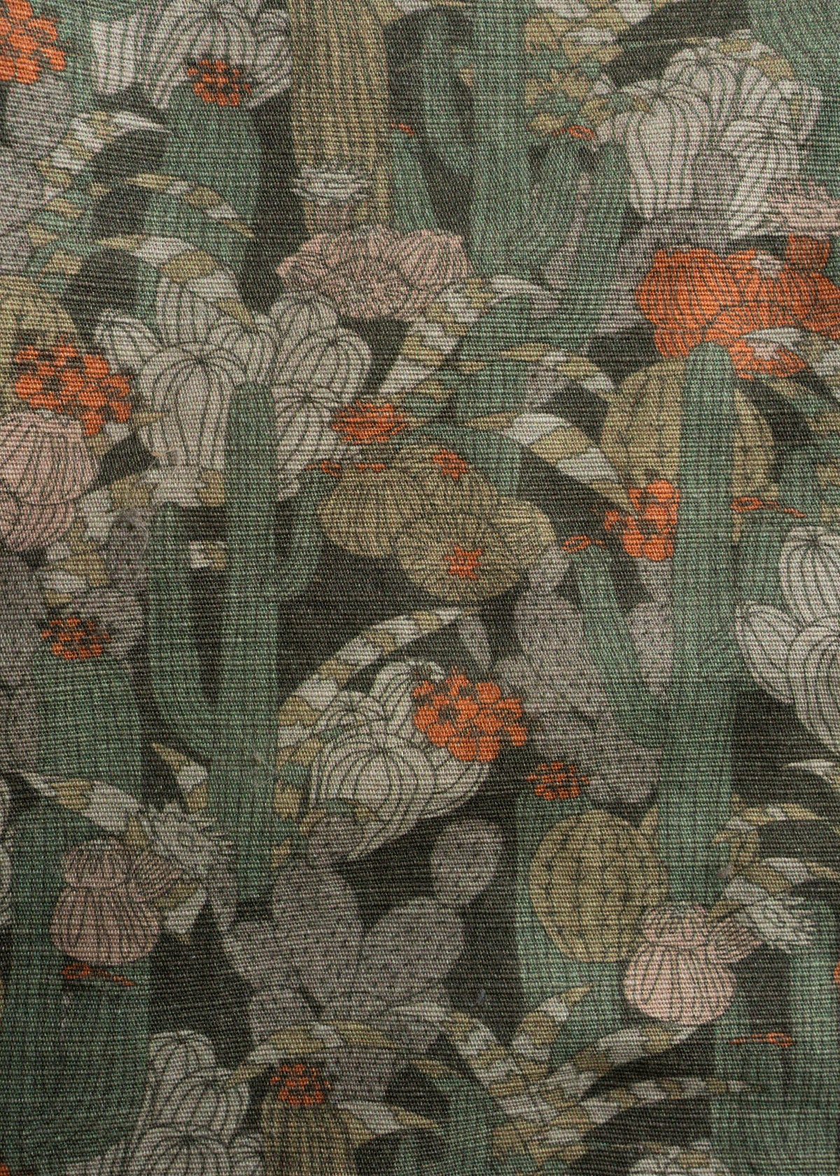 Cactus pattern with orange and pink flowers on textured fabric, featuring green and brown tones, creating a desert-themed design.