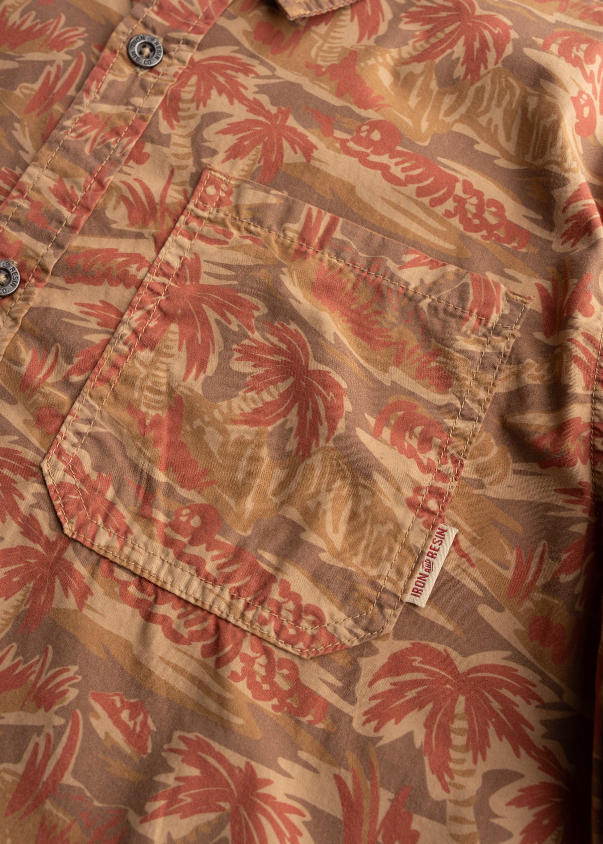 Men’s poplin cotton button up shirt with custom camo print and metal buttons, showcasing detail of fabric and chest pocket