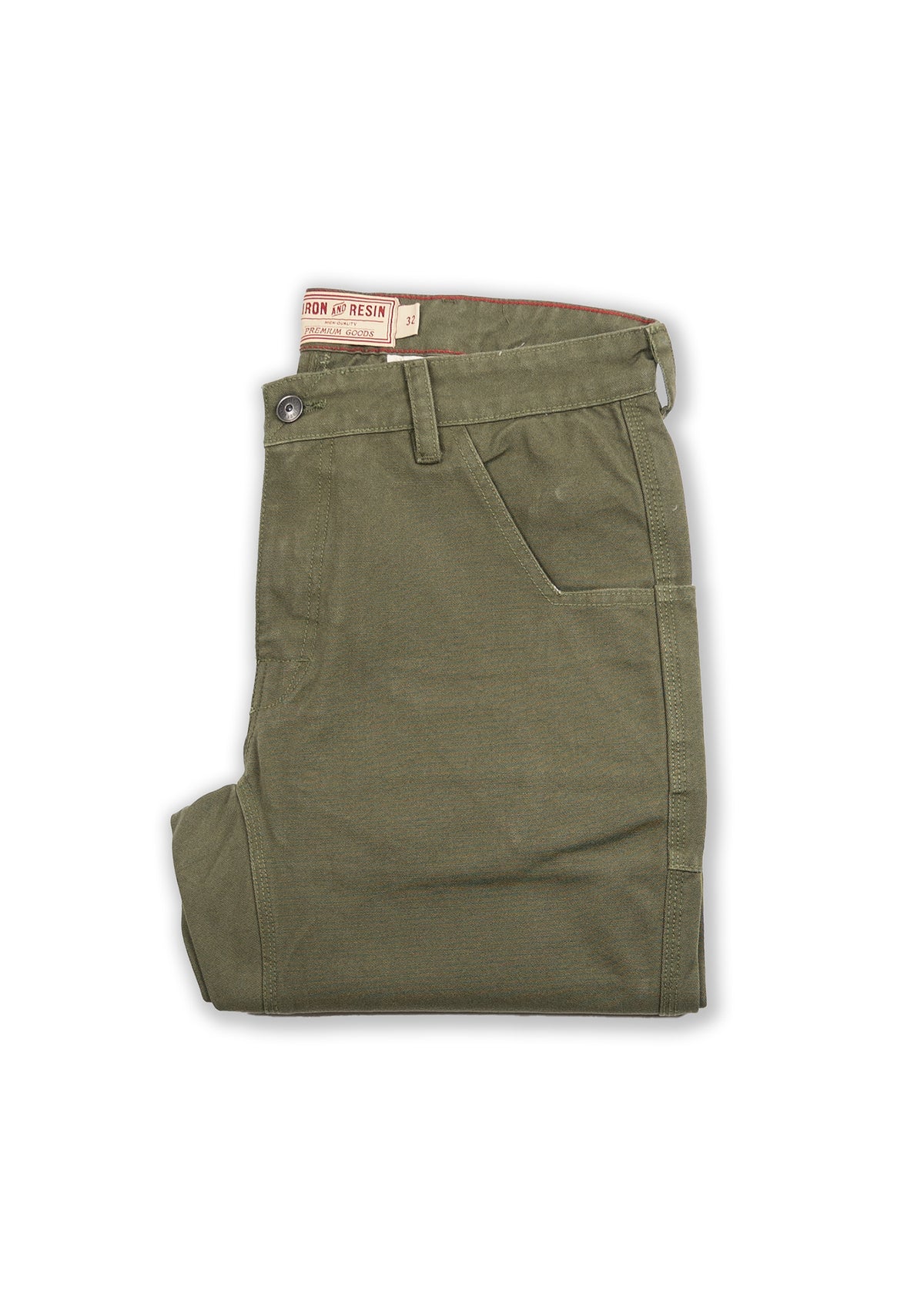 Olive green pants folded neatly, featuring a button closure and side pocket. Visible "Iron & Resin" label on the waistband.