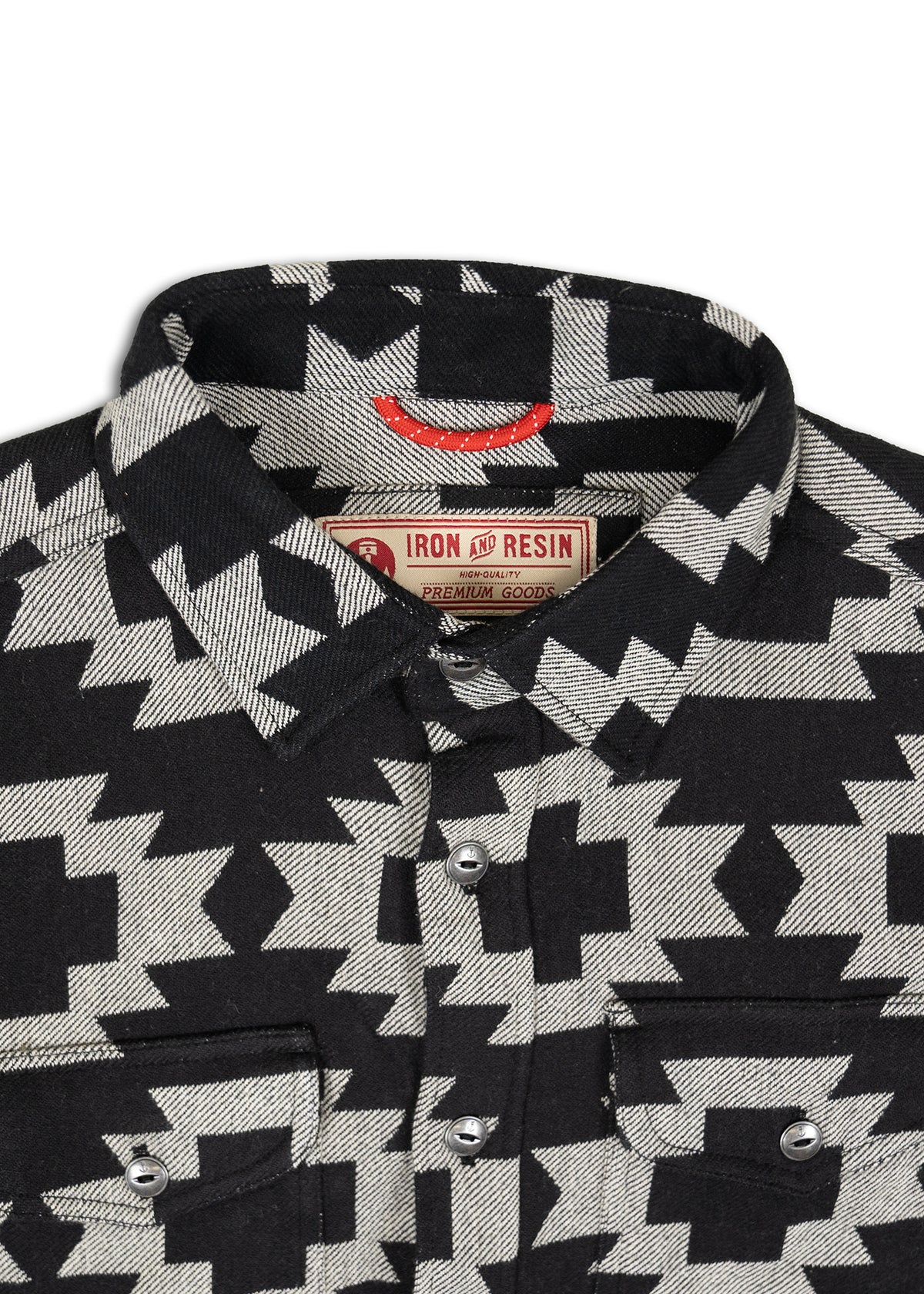 Black and white geometric patterned shirt with Iron and Resin label, featuring buttoned pockets and a classic collar design.