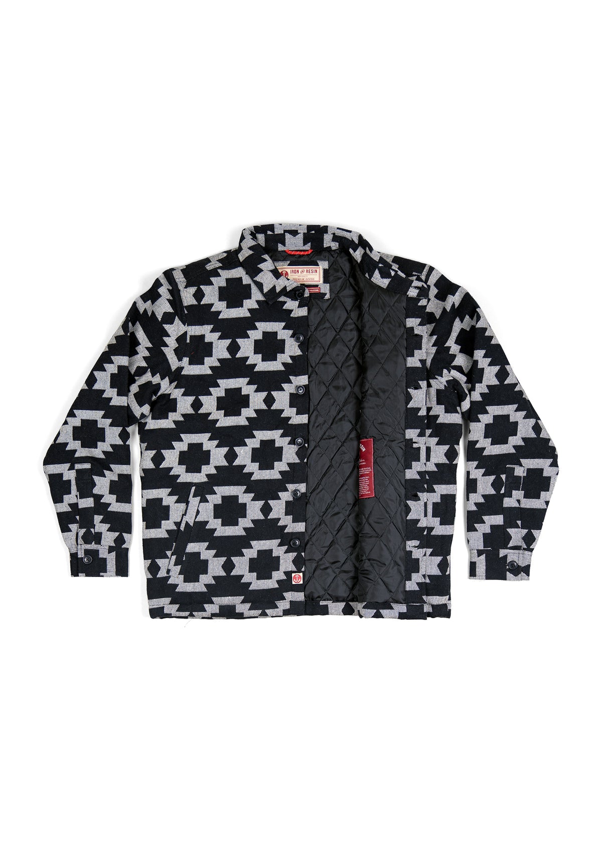 Black and white geometric patterned jacket with quilted lining, open to reveal interior details and tags.