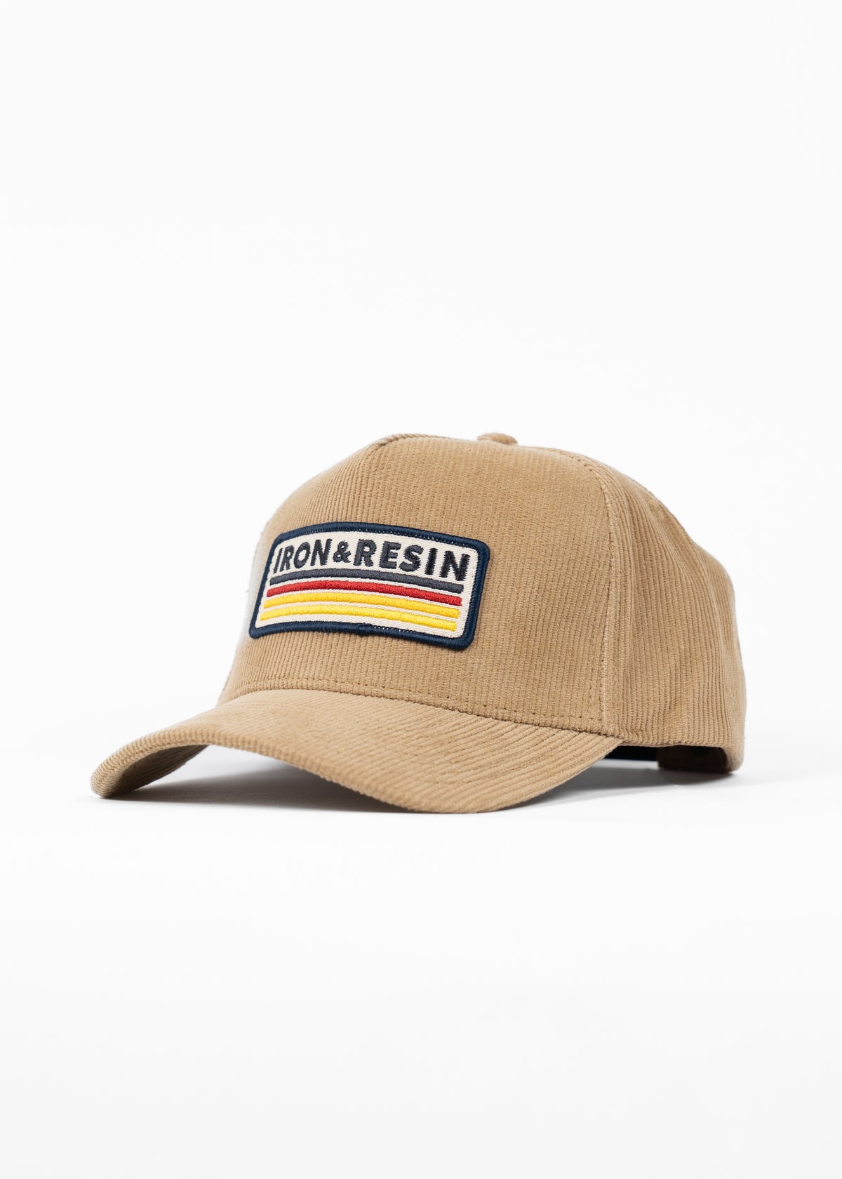Tan corduroy cap with "Iron & Resin" patch, featuring colorful stripes, on a white background.