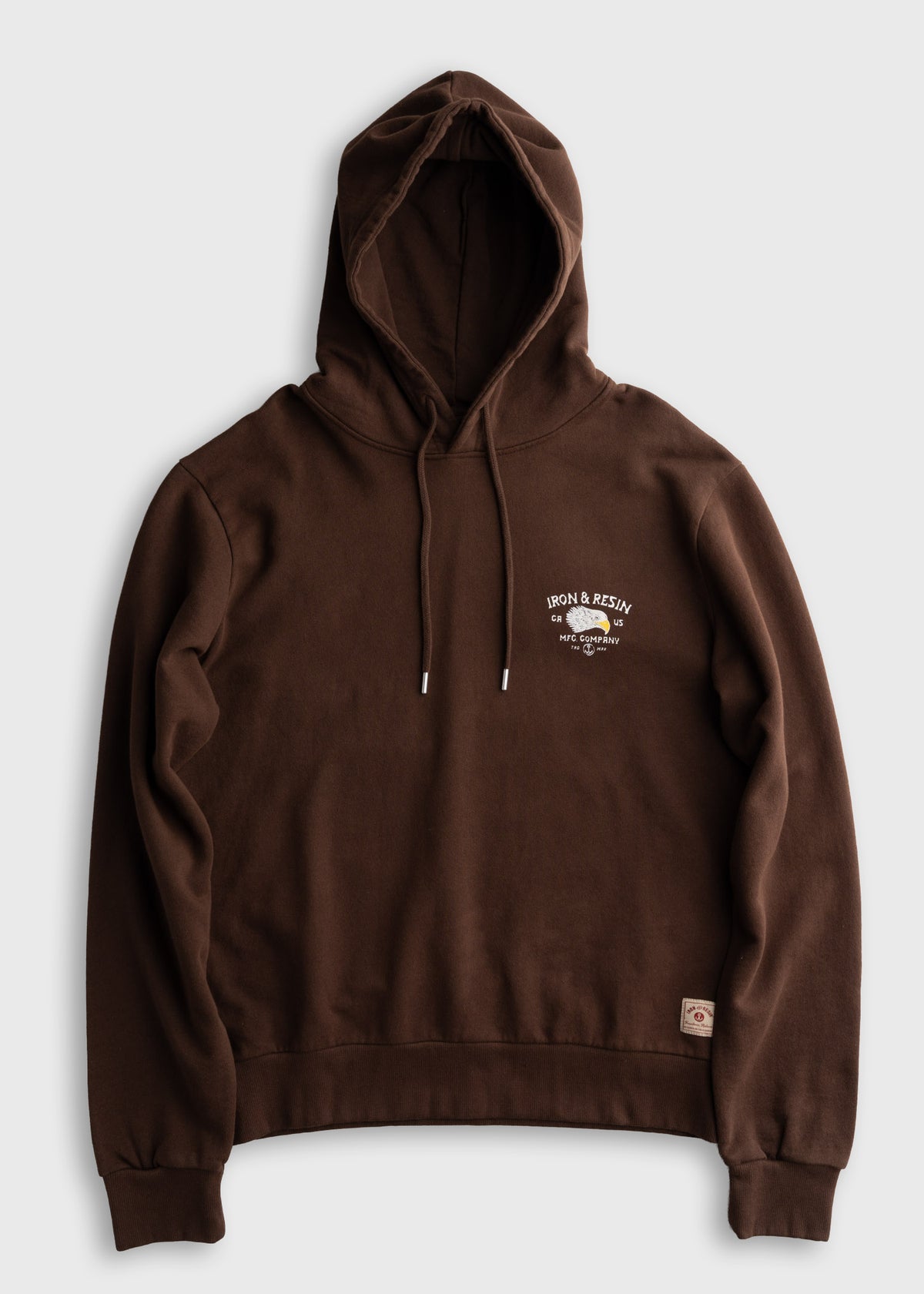 Brown hoodie with "Iron & Resin" logo on chest, featuring a drawstring hood and ribbed cuffs, displayed on a plain background.