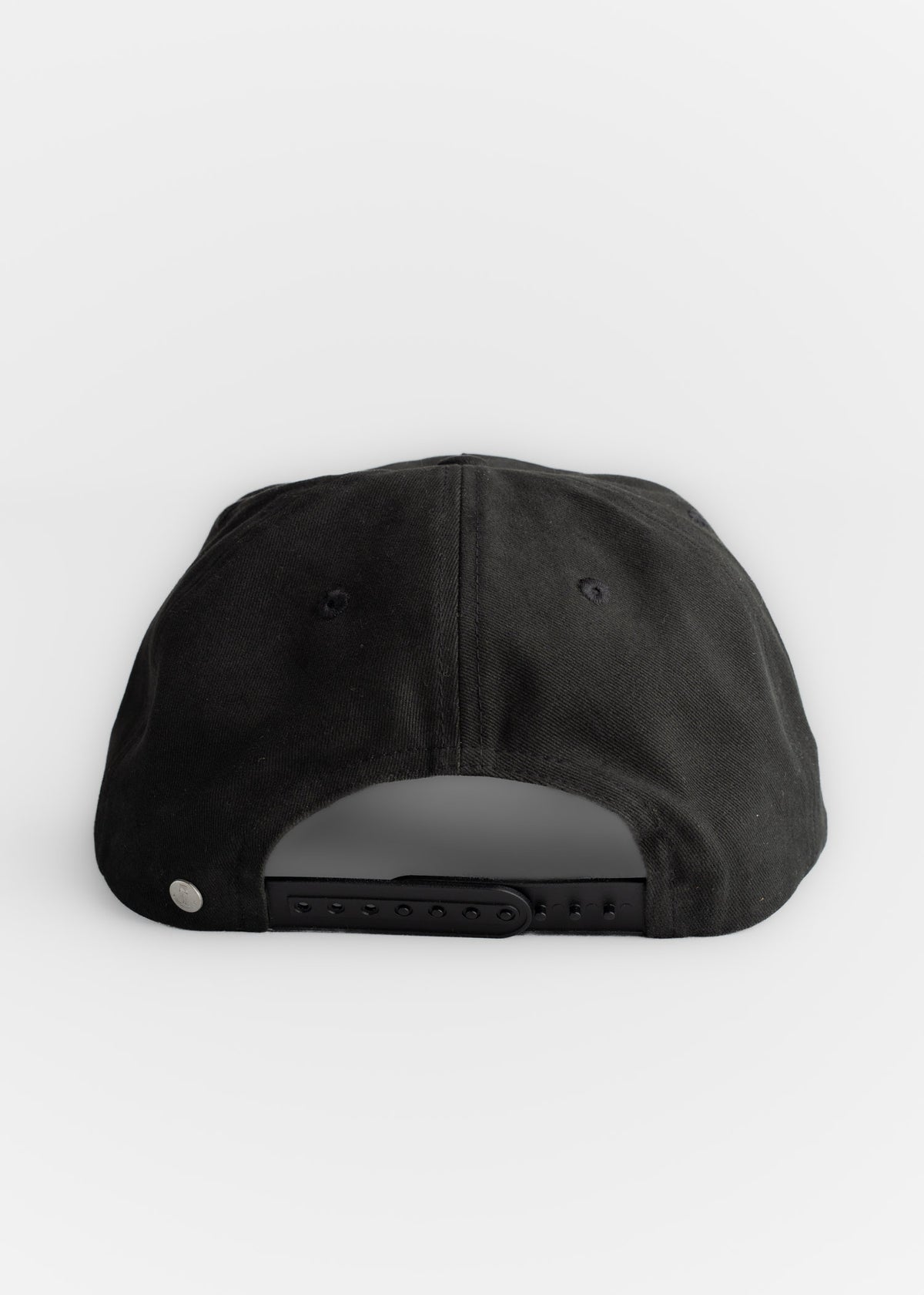 Black cap with adjustable strap and metal button on a white background, viewed from the back.