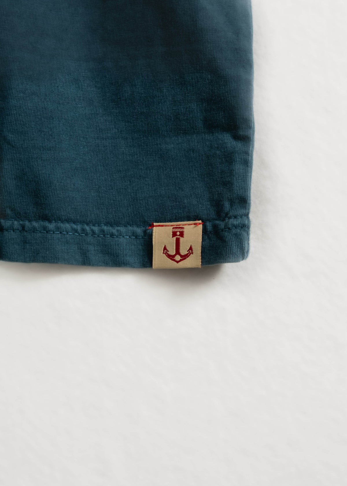 Faded Pocket Tee showcasing detail of fabric, and custom logo tag