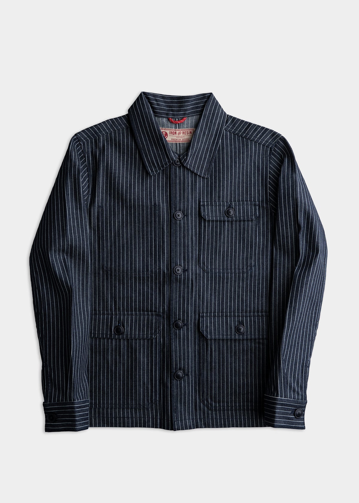 Navy pinstripe jacket with buttoned pockets and collar, displayed on a white background, showcasing classic style and design.