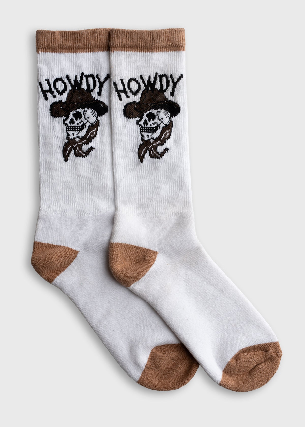 White socks with brown accents feature a cowboy skull and "Howdy" text, blending Western style with playful design.