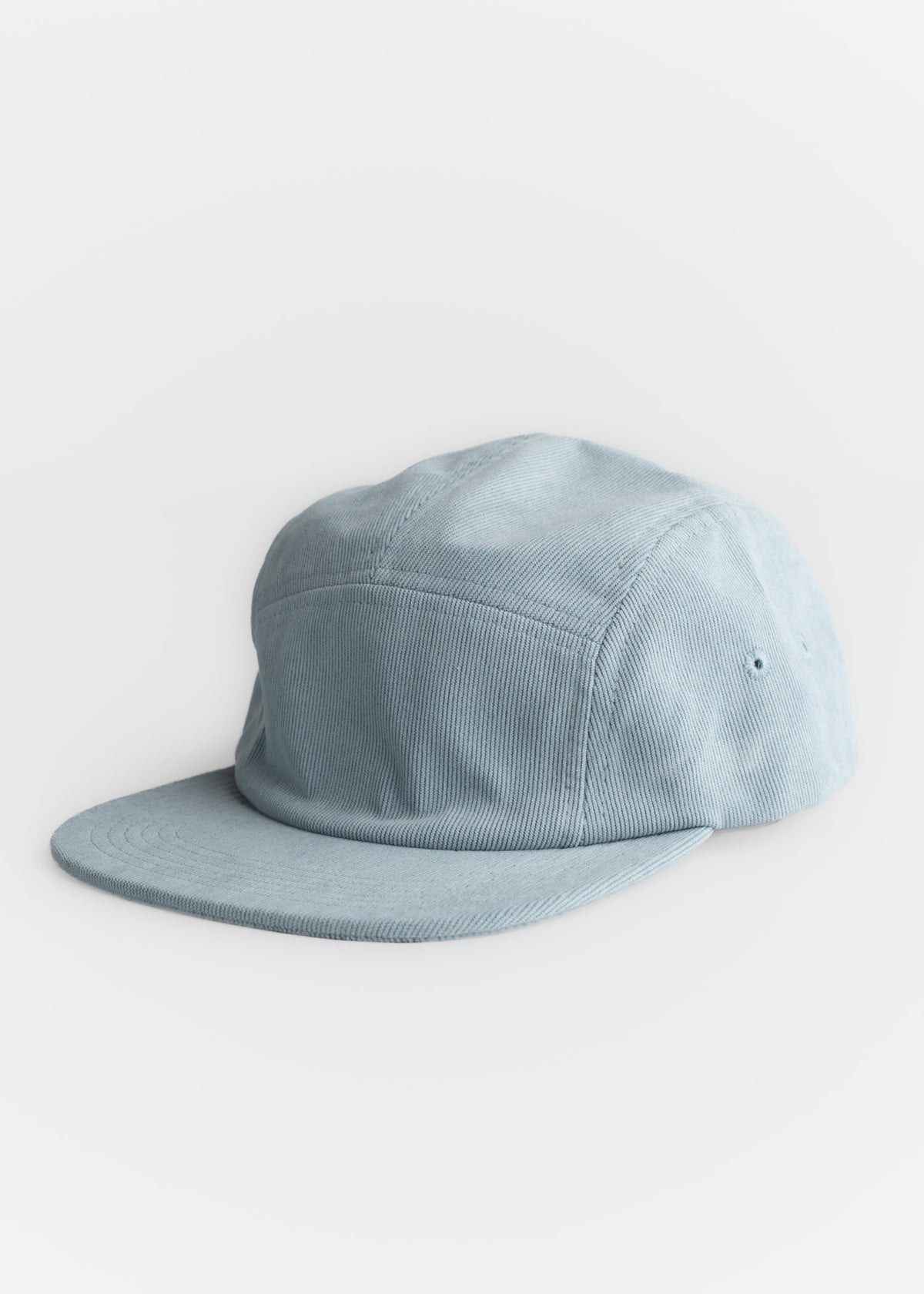 Light blue corduroy cap with a flat brim, displayed on a white background, showcasing its casual and stylish design.