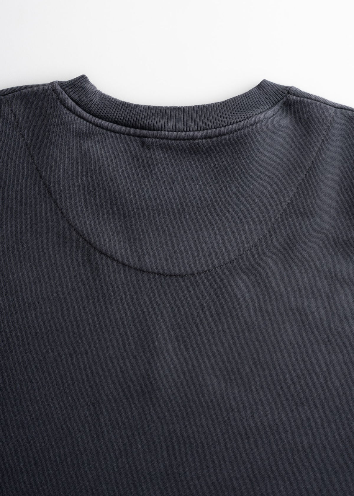 Close up of ribbed collar on crewneck sweatshirt, highlighting fit and structure