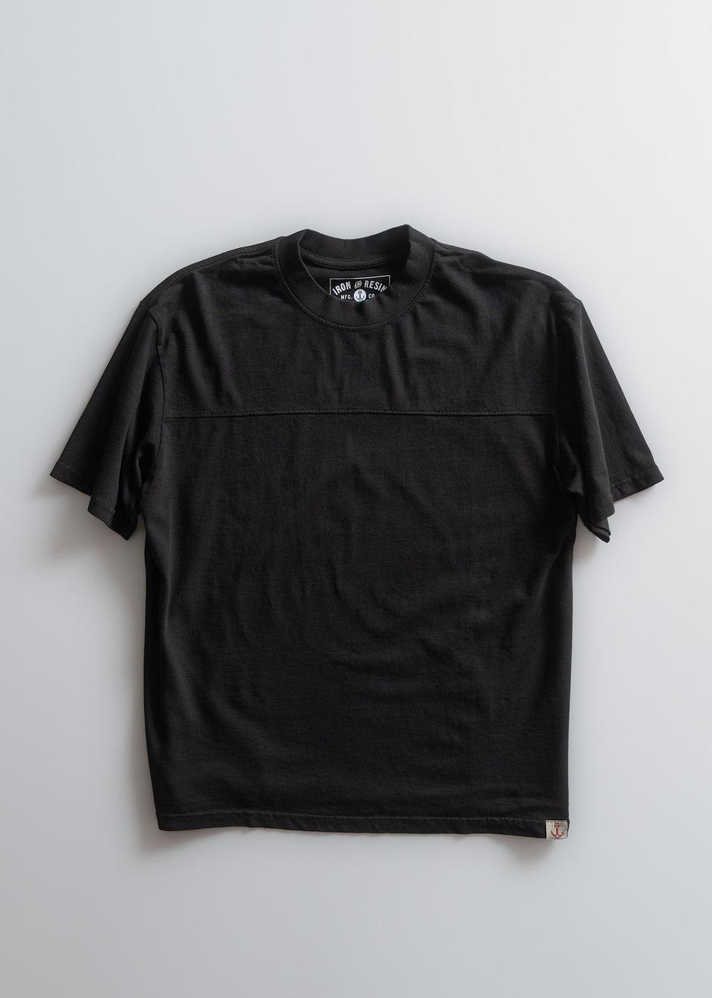 Black short-sleeve T-shirt with a round neck and subtle stitching, displayed flat on a light background.