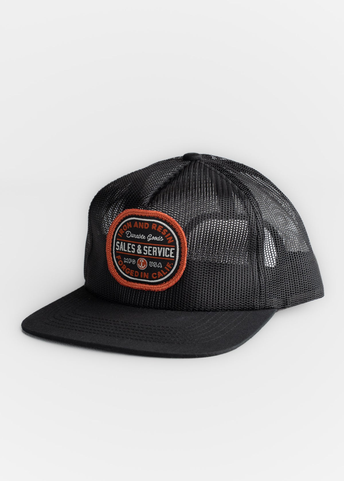 Black mesh cap with "Sales & Service" patch, orange trim, and "Forged in Calif." text, angled on a white background.
