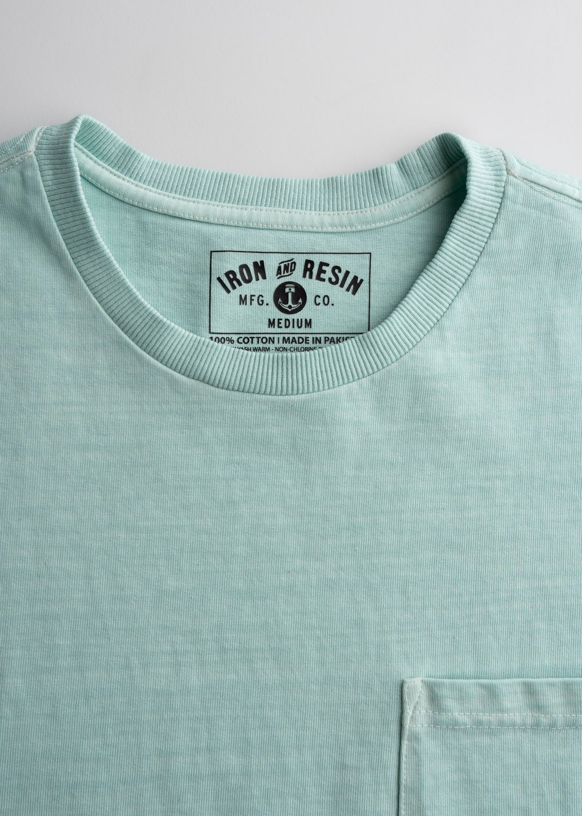 Close-up of men’s 10.25 oz heavyweight jersey cotton t-shirt in Aqua, detailing durable construction and soft feel