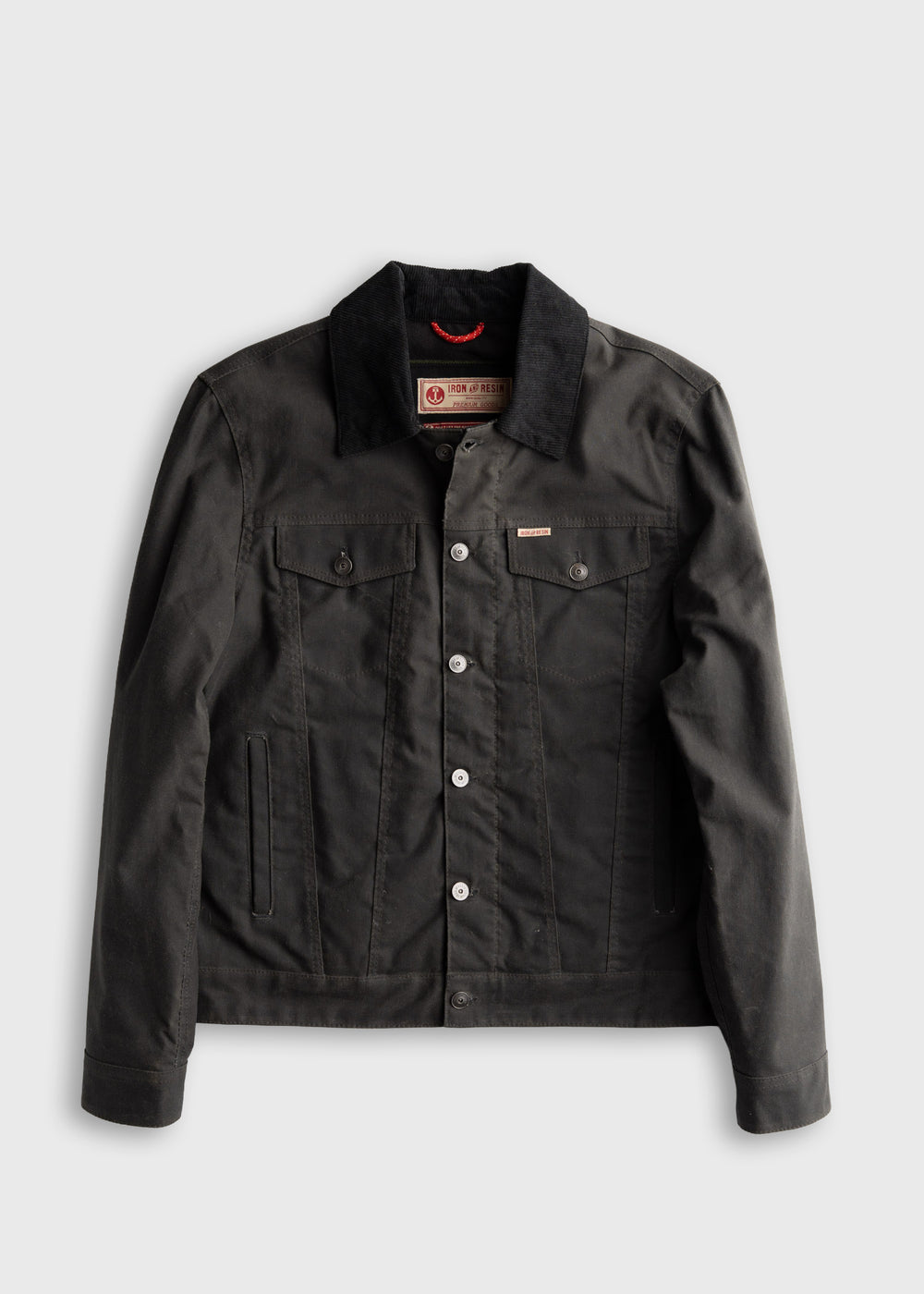 Black denim jacket with button closure, two chest pockets, and a corduroy collar, displayed on a plain background.
