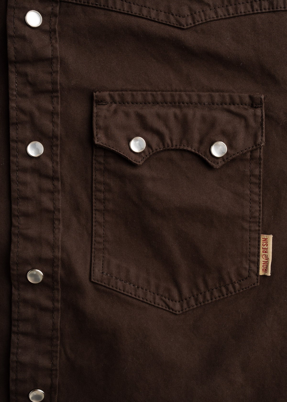 Close up of dual chest pocket on Prescott twill shirt with pearl snap closure, highlighting stitching and utility design
