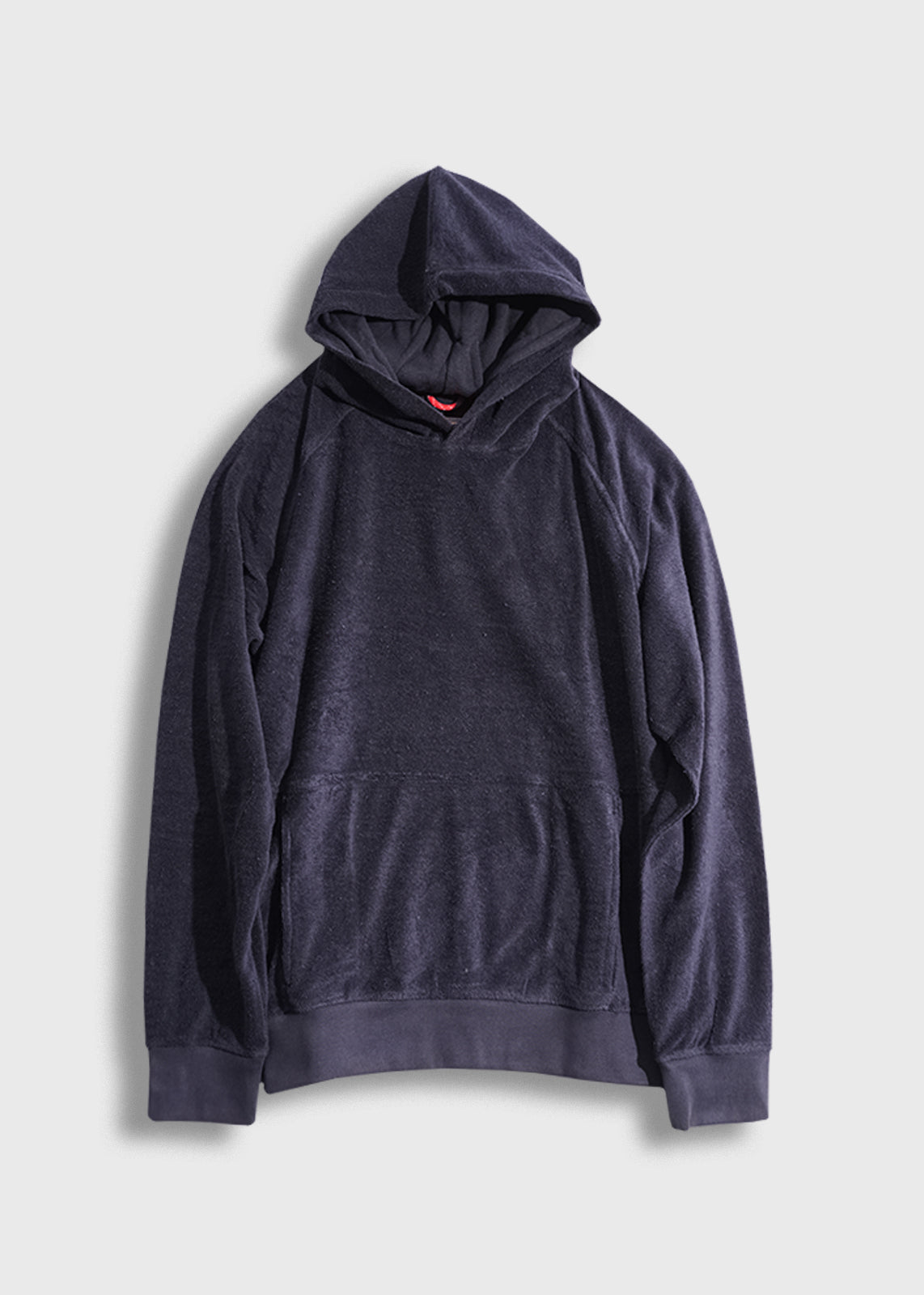 Dark blue hoodie with a front pocket and hood, laid flat on a light gray background, showcasing its casual style.