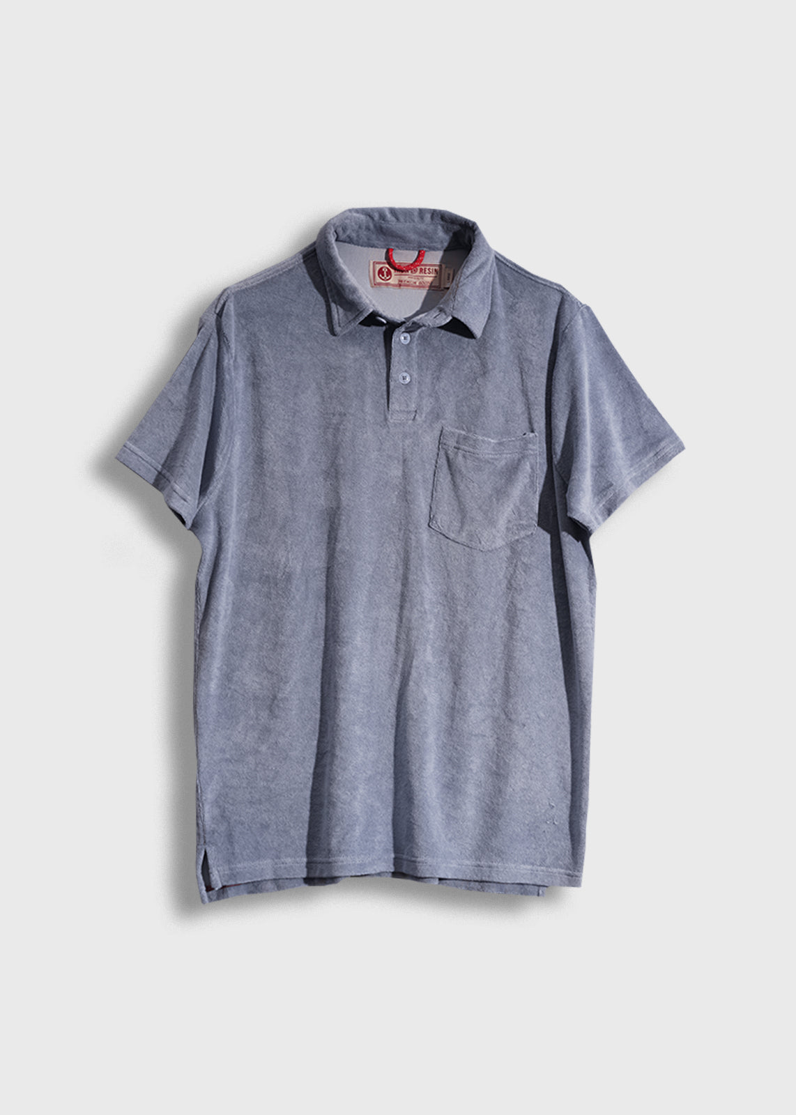 Blue short-sleeve polo shirt with a pocket, buttoned collar, and visible tag, displayed on a plain white background.