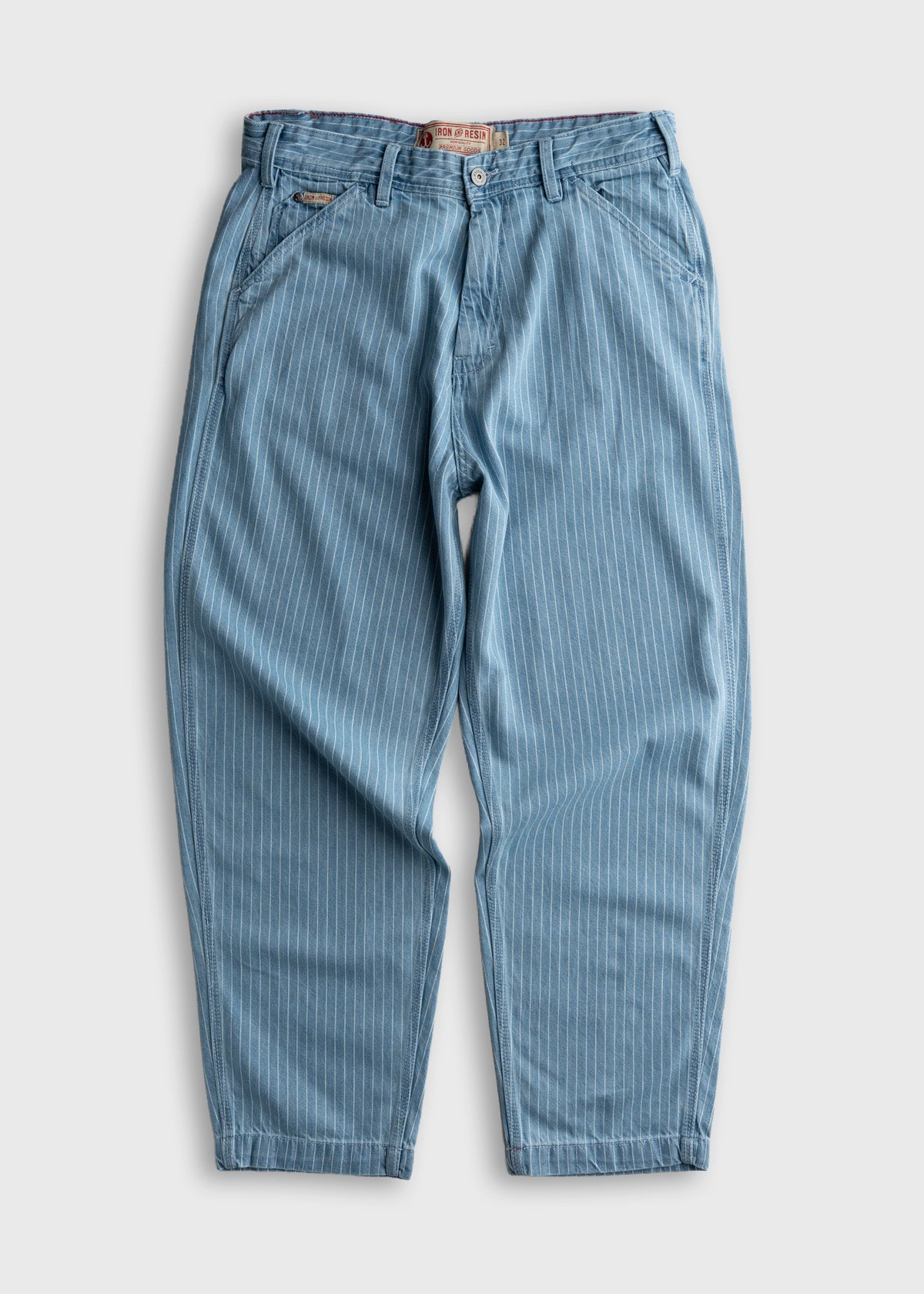 Blue pinstripe pants with a button closure and belt loops, laid flat on a white background, showcasing casual style.