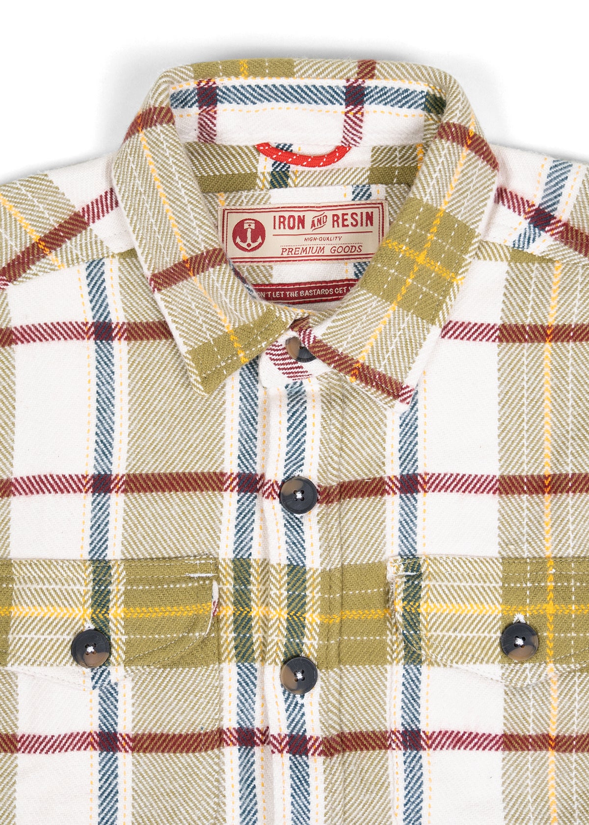 Plaid shirt with green, red, and blue stripes, featuring "Iron and Resin" label. Black buttons and chest pockets visible.